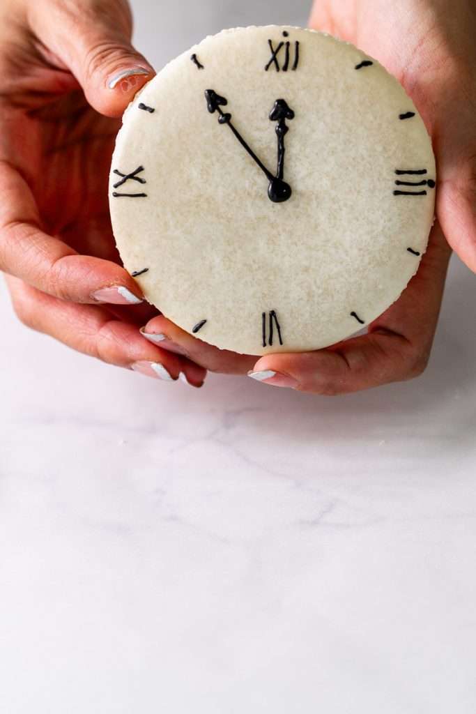 Chocolate hazelnut macaron cake decorated with a Roman numeral clock design for New Years Eve. Dairy Free & Gluten Free. Recipe & Tutorial.