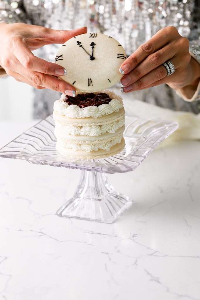 Chocolate hazelnut macaron cake decorated with a Roman numeral clock design for New Years Eve. Dairy Free & Gluten Free. Recipe & Tutorial.
