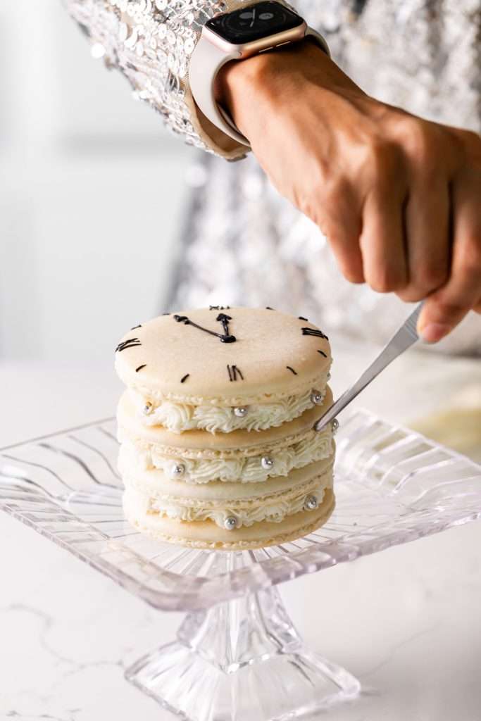 Chocolate hazelnut macaron cake decorated with a Roman numeral clock design for New Years Eve. Dairy Free & Gluten Free. Recipe & Tutorial.