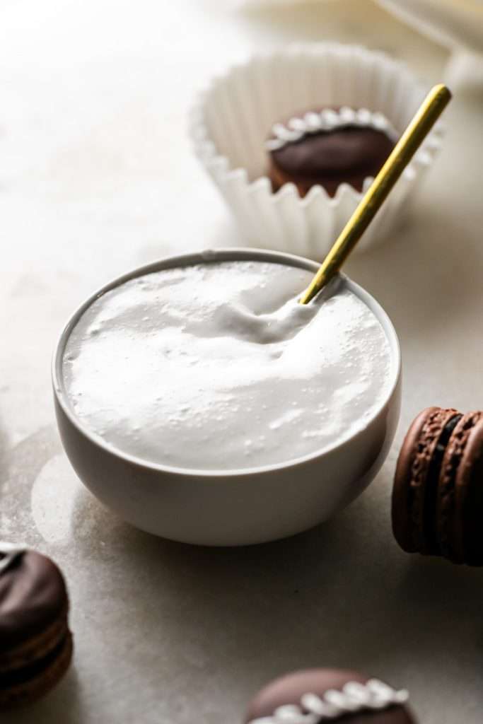 Easy marshmallow filling for macarons, cookies and cakes made with egg whites, granulated sugar and gelatin.