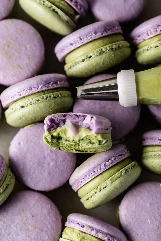 Indulge in a delicious lavender matcha macaron, inspired by the new Starbucks Lavender Matcha latte. From the earthy matcha frosting to the the delicate lavender chocolate ganache sandwiched between two tone almond macaron shells, they are not only delicious but perfect for your upcoming spring gatherings!