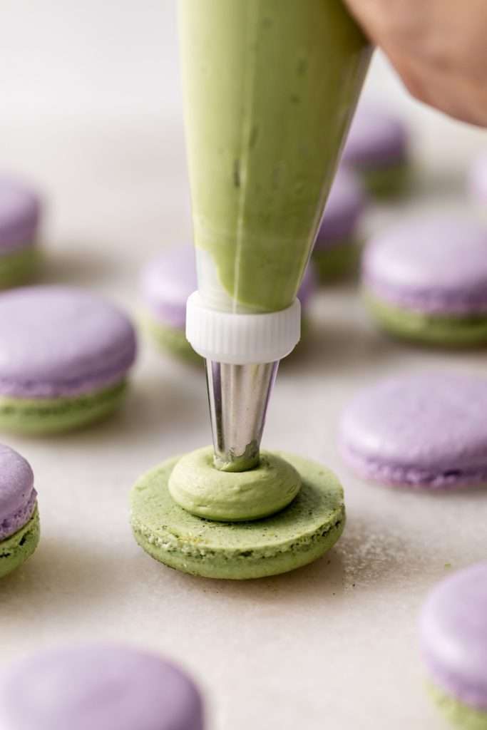 Indulge in a delicious lavender matcha macaron, inspired by the new Starbucks Lavender Matcha latte. From the earthy matcha frosting to the the delicate lavender chocolate ganache sandwiched between two tone almond macaron shells, they are not only delicious but perfect for your upcoming spring gatherings!