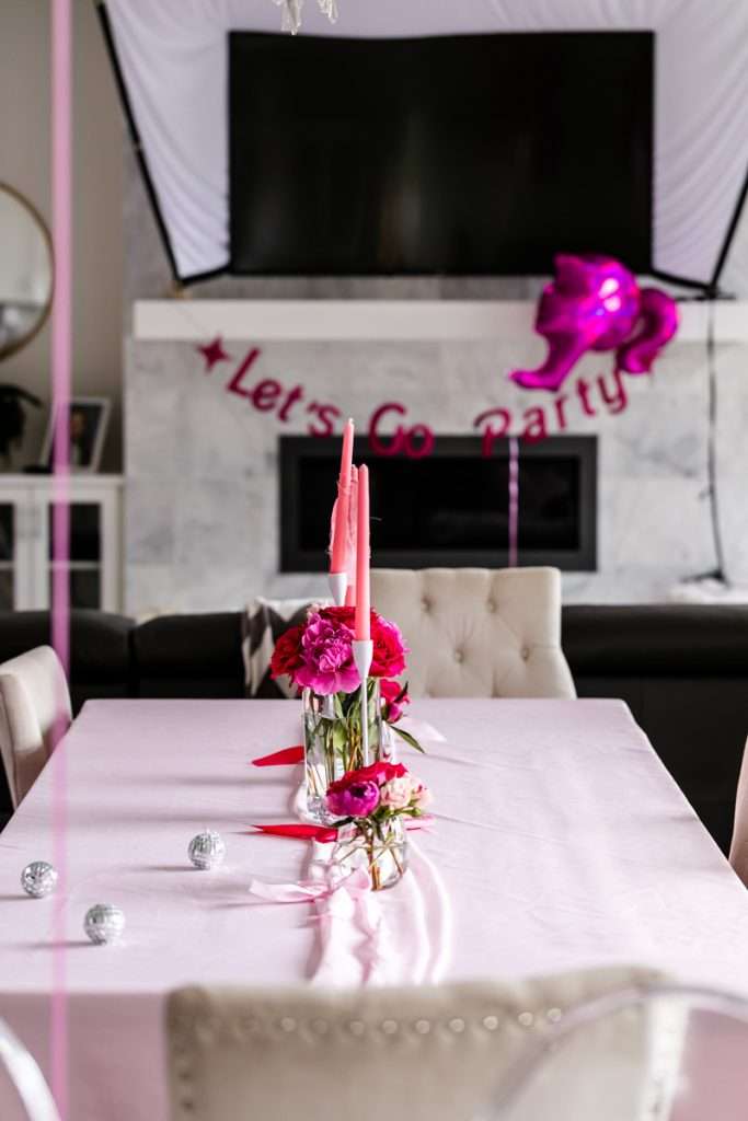 How to throw a Barbie Birthday Party, complete with pink Barbie decor, a life-size barbie box, custom barbie desserts, and details to highlight the iconic theme and movie. Links to all products shared in the post!