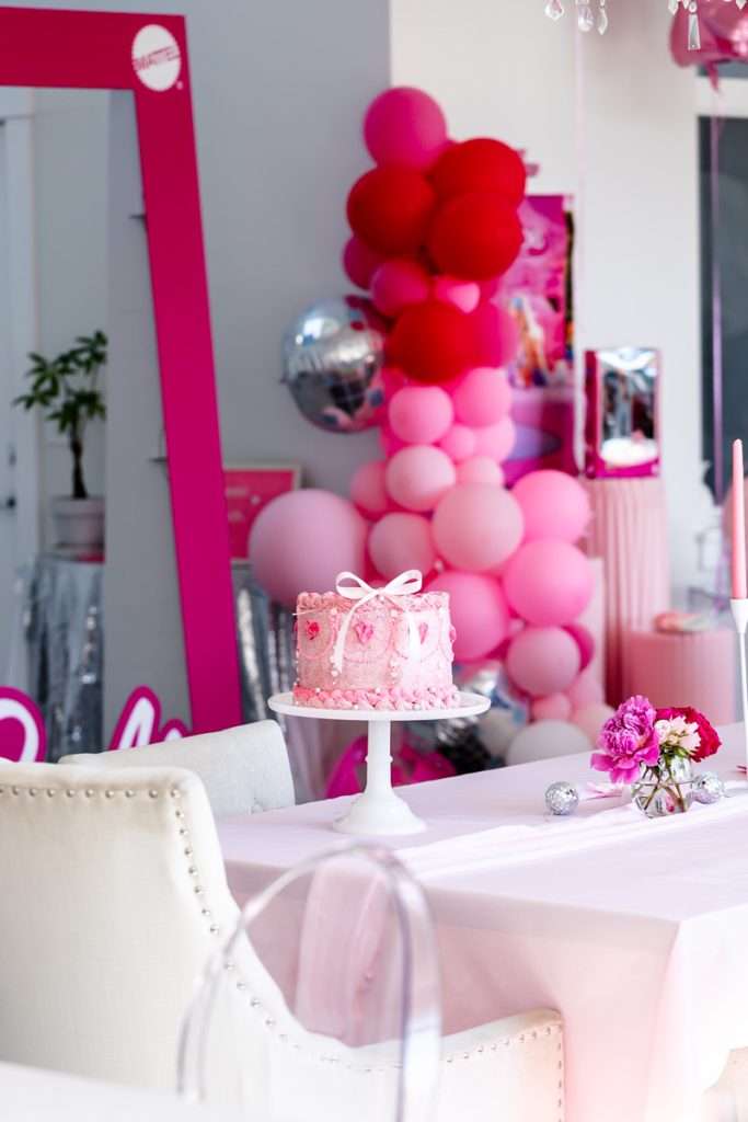 How to throw a Barbie Birthday Party, complete with pink Barbie decor, a life-size barbie box, custom barbie desserts, and details to highlight the iconic theme and movie. Links to all products shared in the post! #barbieparty #barbiemovie