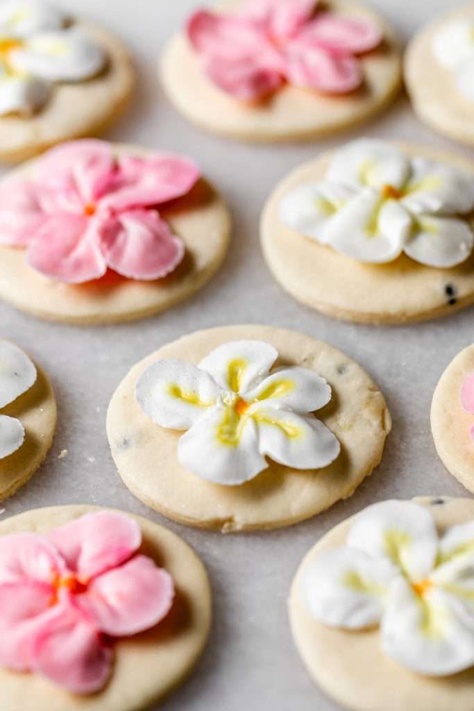 Recipe for tropical sugar cookies, infused with fresh passion fruit and decorated with plumeria royal icing transfers. Step by step instructions and video included.