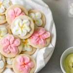 Recipe for tropical sugar cookies, infused with fresh passion fruit and decorated piped with plumeria royal icing transfers. Step by step instructions and video included.