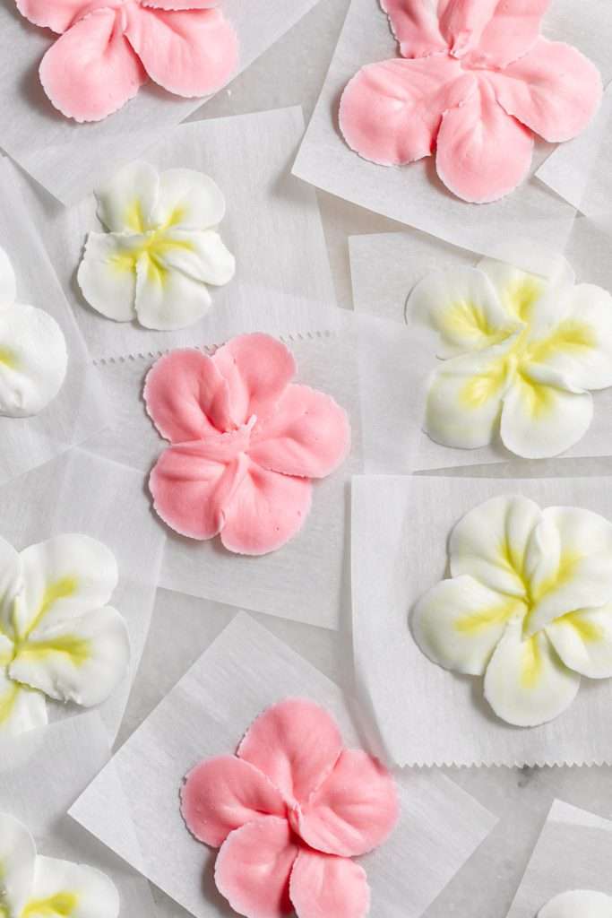 Recipe for tropical sugar cookies, infused with fresh passion fruit and decorated with plumeria royal icing transfers. Step by step instructions and video included.