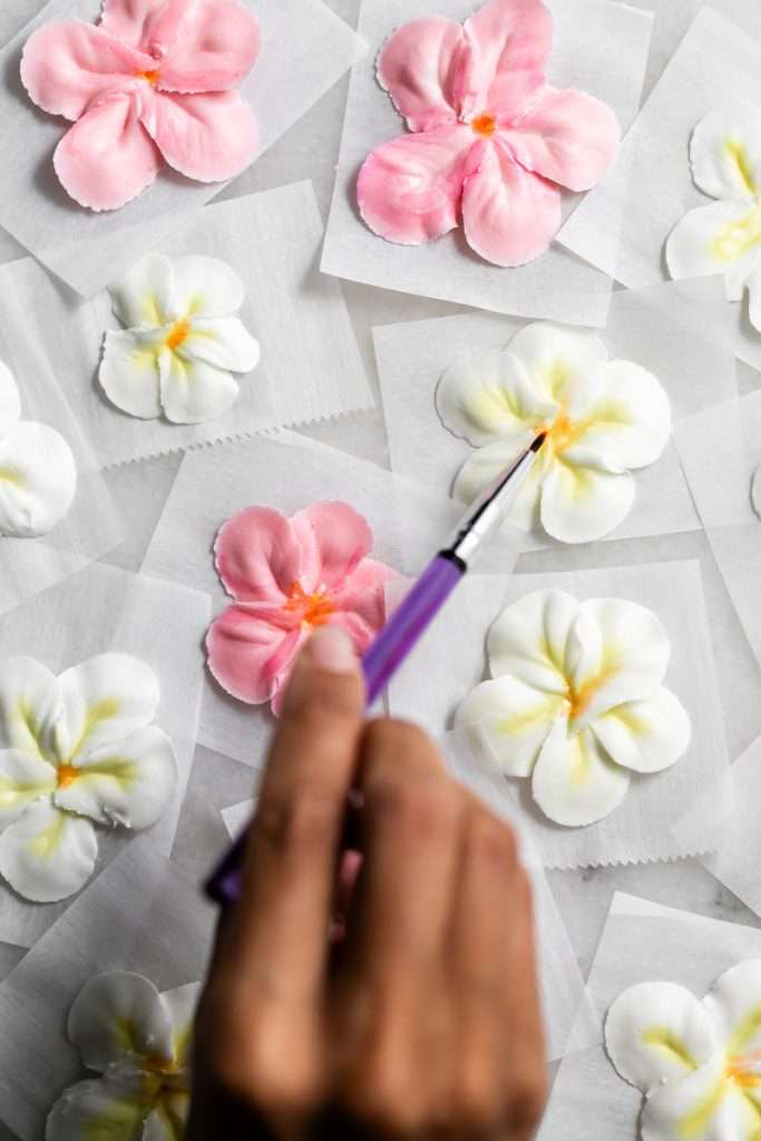 Recipe for tropical sugar cookies, infused with fresh passion fruit and decorated with plumeria royal icing transfers. Step by step instructions and video included.