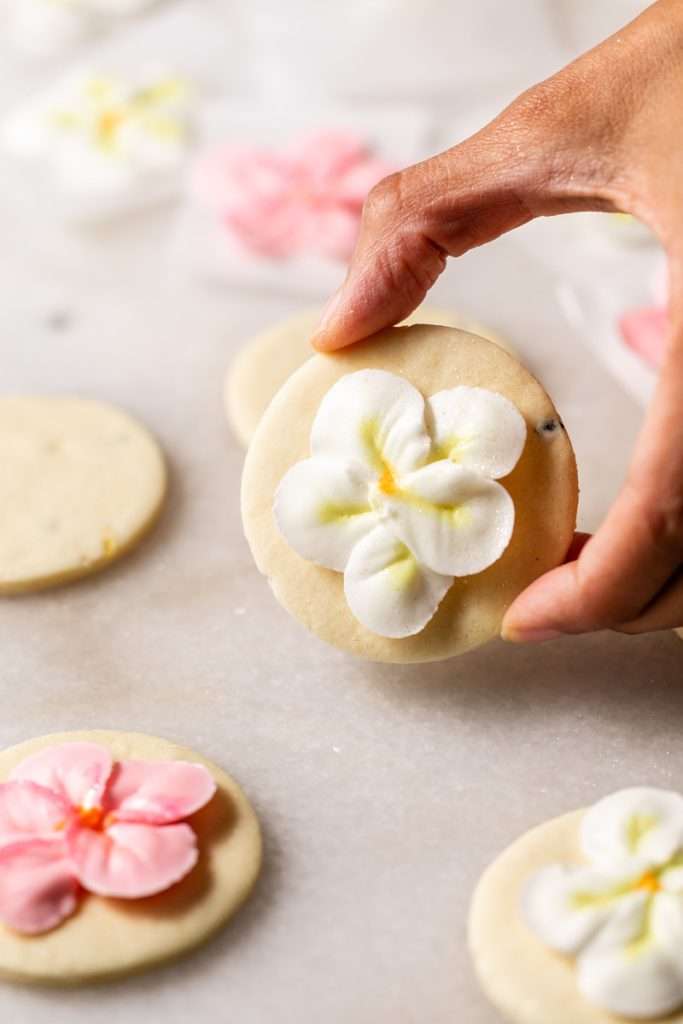 Recipe for tropical sugar cookies, infused with fresh passion fruit and decorated with plumeria royal icing transfers. Step by step instructions and video included.