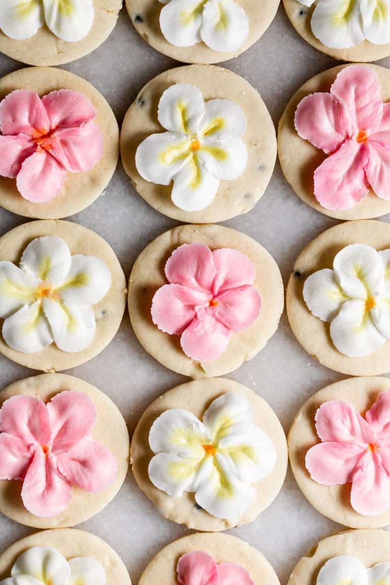 Recipe for tropical sugar cookies, infused with fresh passion fruit and decorated piped with plumeria royal icing transfers. Step by step instructions and video included.