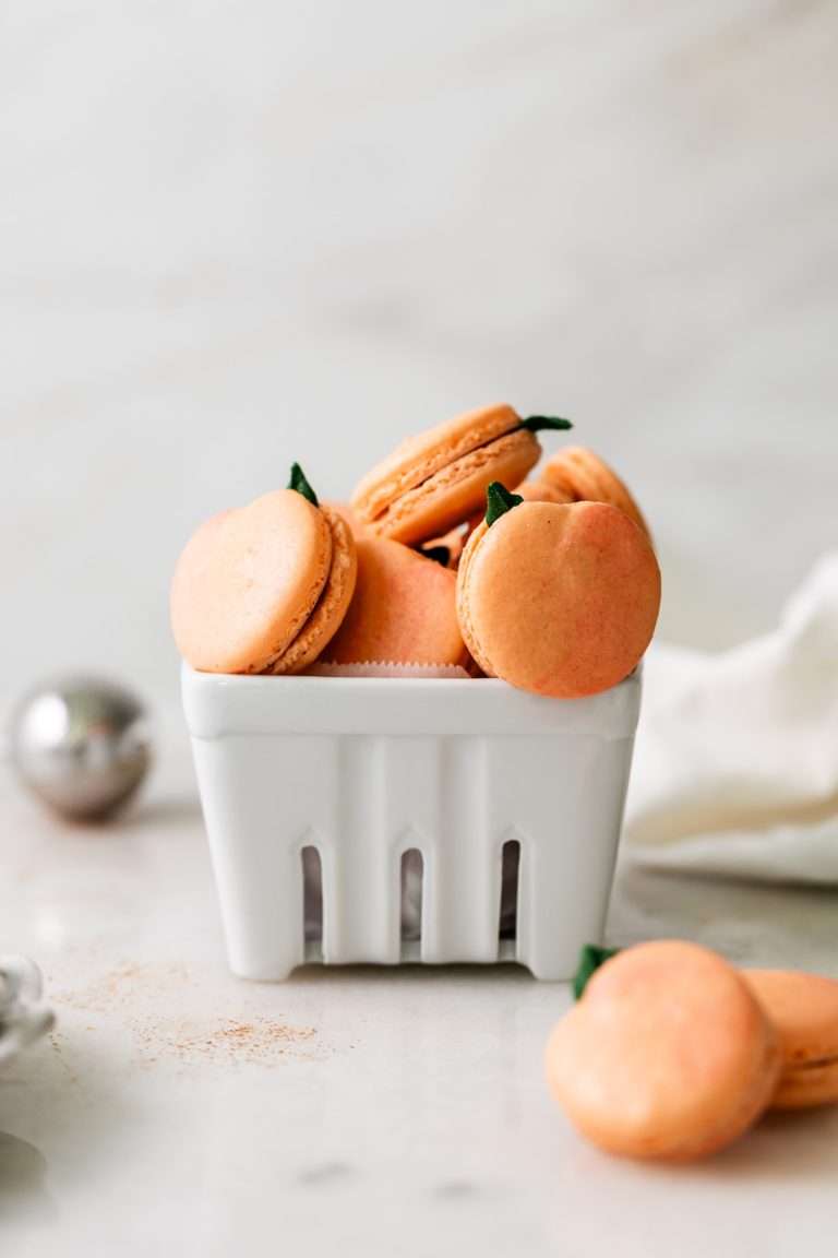 Recipe for peach cobbler flavored French macarons with fresh peach jam and spiced cobbler topping. Perfect for your end of summer gatherings. Dairy Free GF option included.