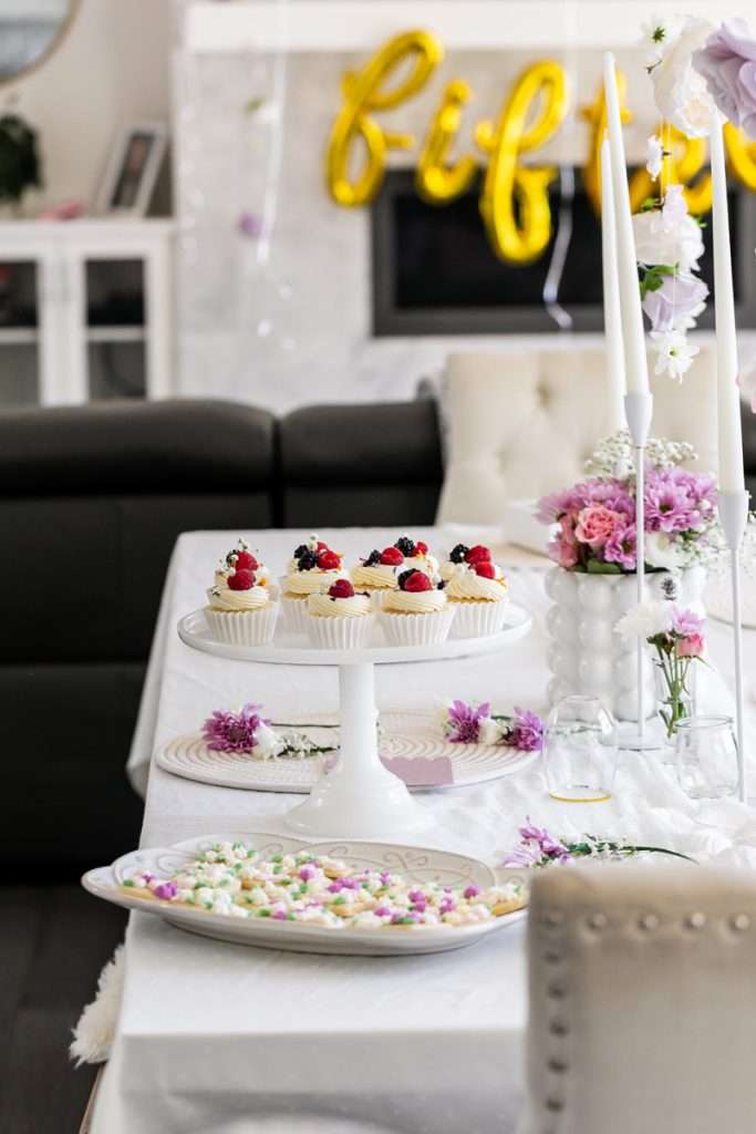 Flower themed birthday party with berry and floral cupcakes, sugar cookies and flower decor