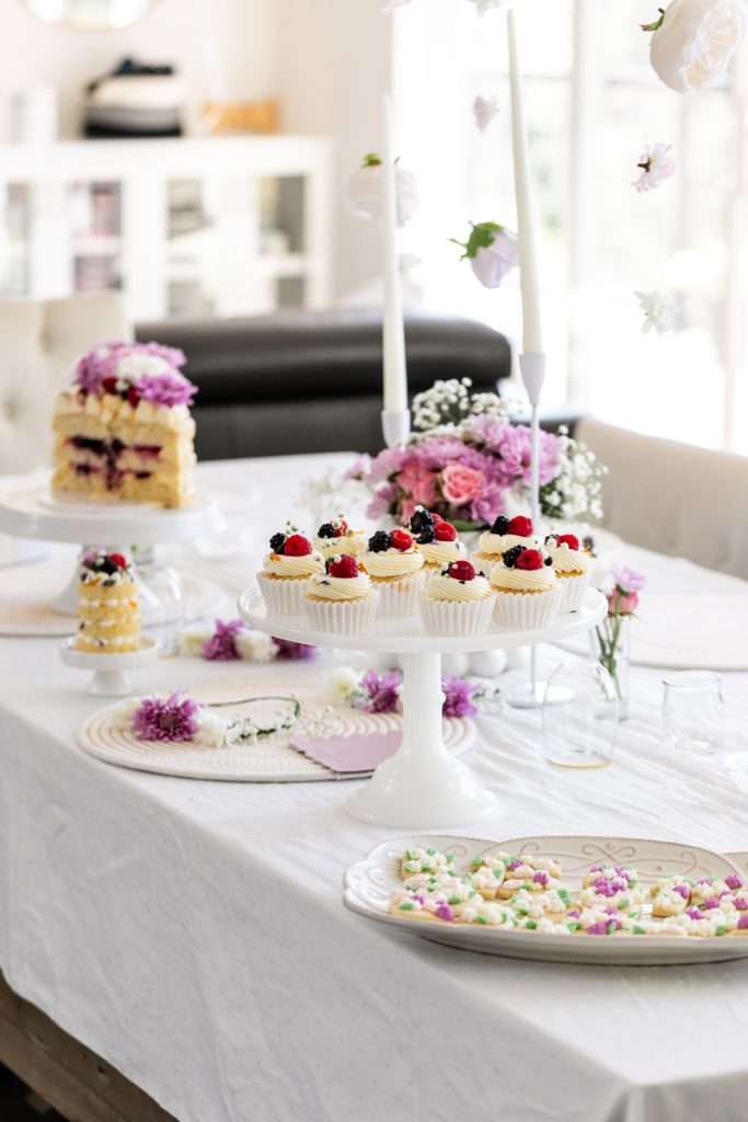 Flower themed birthday party with berry and floral cupcakes, sugar cookies and flower table decor