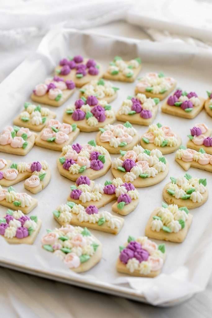 Flower piped sugar cookies for a flower themed 15th birthday party.