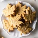 Easy and delicious maple leaf cookies, inspired by Canadian maple cookies filled with maple buttercream and simply decorated with edible gold. A wonderful treat for the fall season and for upcoming fall gatherings. Dairy free option included.