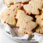 Peppermint tree sugar cookies infused with crushed peppermint and vanilla bean. Decorated simply with modern branch lines, silver leaf and powdered sugar. An easy, delicious and festive contender for your holiday cookie baking lineup.
