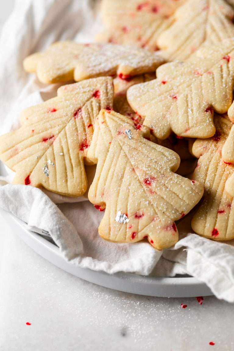 Peppermint tree sugar cookies infused with crushed peppermint and vanilla bean. Decorated simply with modern branch lines, silver leaf and powdered sugar. An easy, delicious and festive contender for your holiday cookie baking lineup.