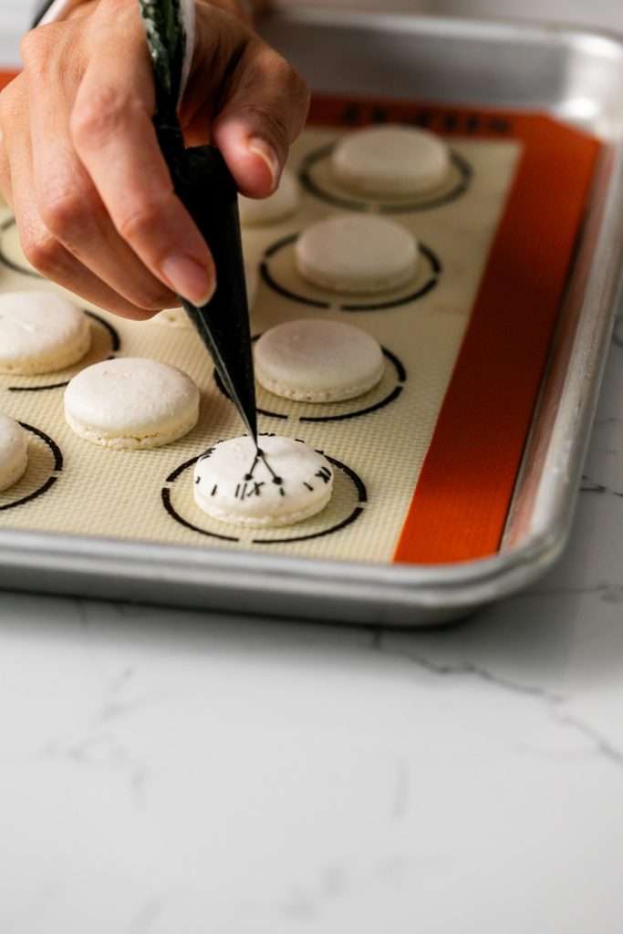 New Years Eve Macarons with royal icing clock decorations