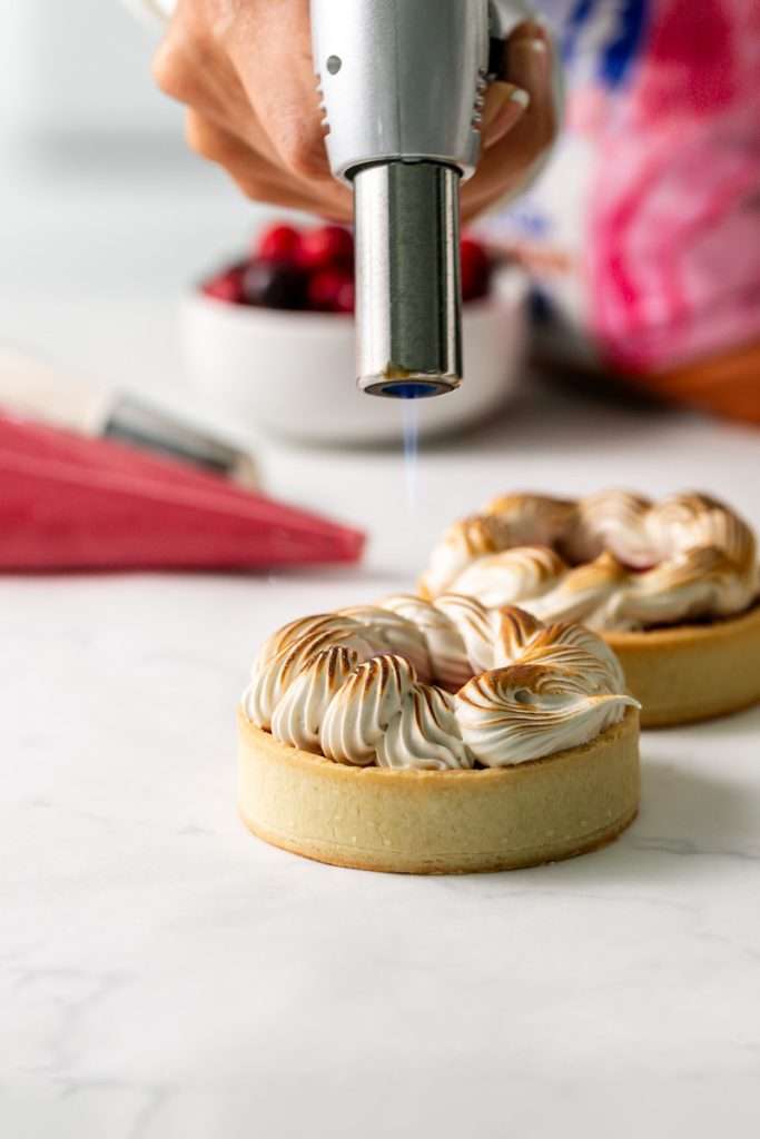 Cranberry tarts with short crust, cranberry curd and toasted brown sugar meringue. Perfect for Thanksgiving and the Holiday season.