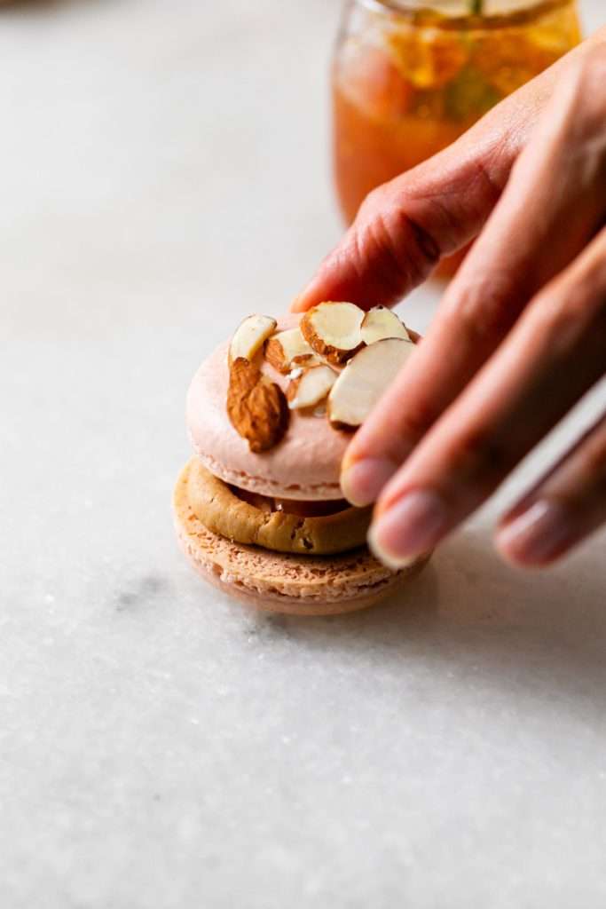 Almond Apricot Macarons filled with almond flavored ganache and apricot preserves. An effortless and delicious macaron flavor for the spring and summer season. Recipe is dairy free and gluten free.
