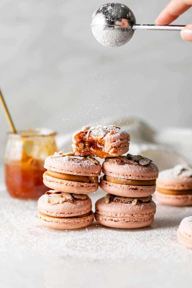 Almond Apricot Macarons filled with almond flavored ganache and apricot preserves. An effortless and delicious macaron flavor for the spring and summer season. Recipe is dairy free and gluten free.