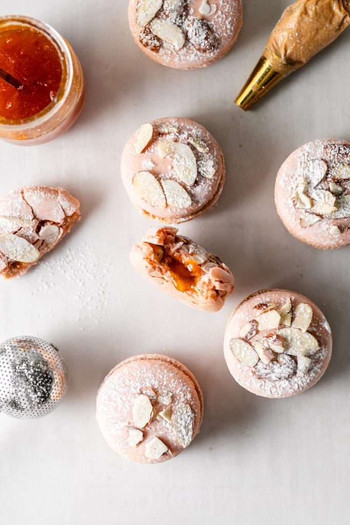 Almond Apricot Macarons filled with almond flavored ganache and apricot preserves. An effortless and delicious macaron flavor for the spring and summer season. Recipe is dairy free and gluten free.