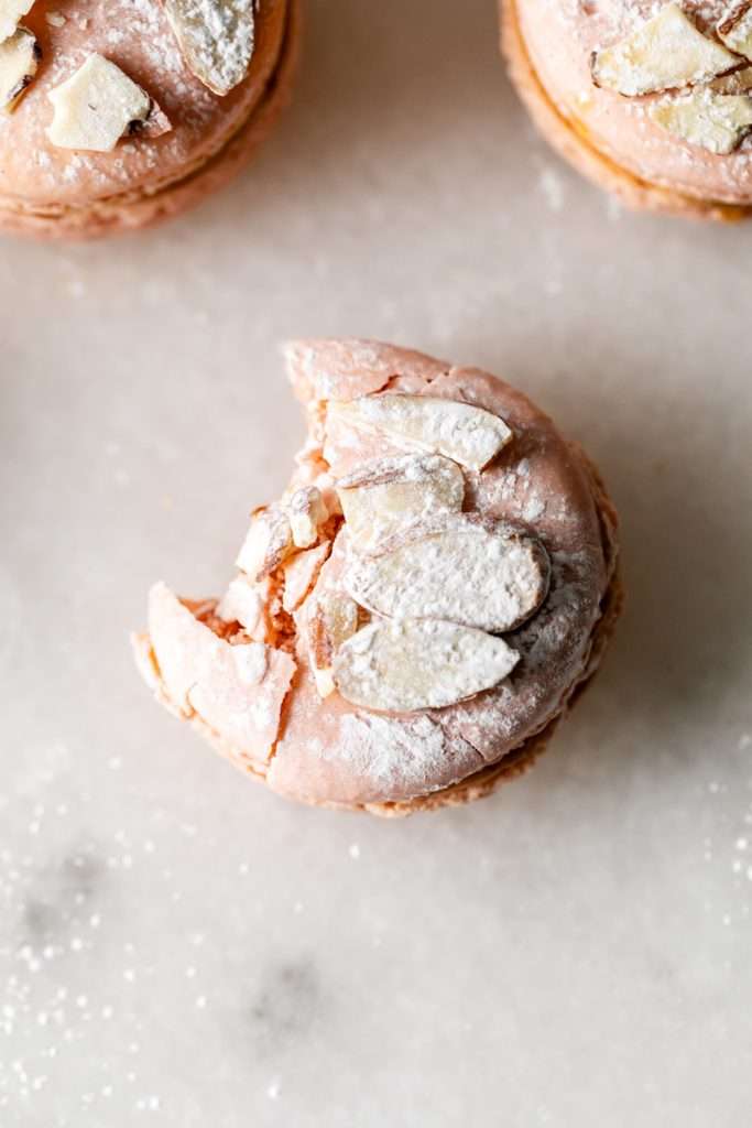 Almond Apricot Macarons filled with almond flavored ganache and apricot preserves. An effortless and delicious macaron flavor for the spring and summer season. Recipe is dairy free and gluten free.