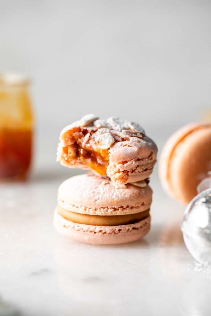 Almond Apricot Macarons filled with almond flavored ganache and apricot preserves. An effortless and delicious macaron flavor for the spring and summer season. Recipe is dairy free and gluten free.