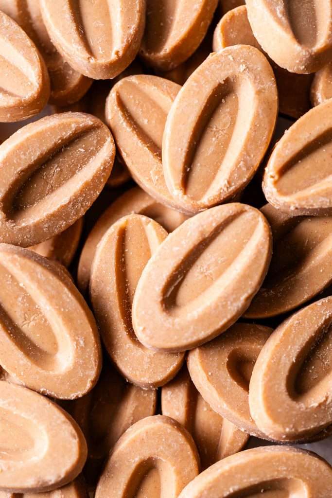 Close up photo of Valrhona Almond Inspiration wafers, used in the almond apricot macarons