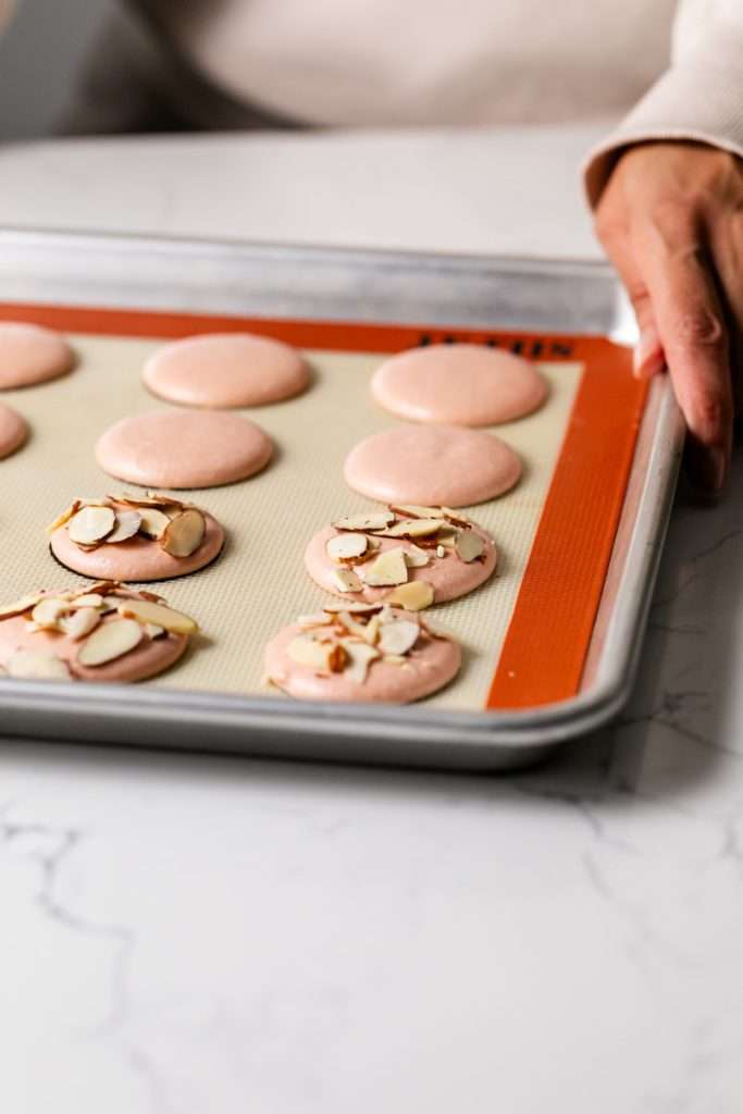 Almond Apricot Macarons filled with almond flavored ganache and apricot preserves. An effortless and delicious macaron flavor for the spring and summer season. Recipe is dairy free and gluten free.