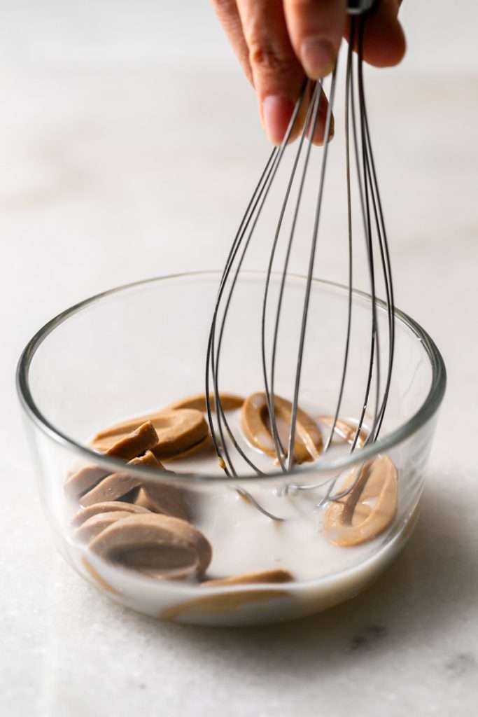 Almond Apricot Macarons filled with almond flavored ganache and apricot preserves. An effortless and delicious macaron flavor for the spring and summer season. Recipe is dairy free and gluten free.
