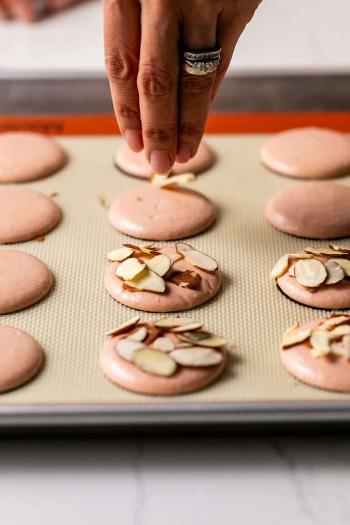 Almond Apricot Macarons filled with almond flavored ganache and apricot preserves. An effortless and delicious macaron flavor for the spring and summer season. Recipe is dairy free and gluten free.