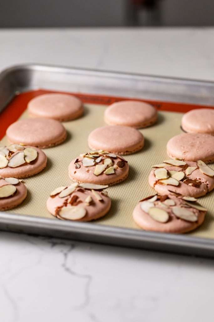 Almond Apricot Macarons filled with almond flavored ganache and apricot preserves. An effortless and delicious macaron flavor for the spring and summer season. Recipe is dairy free and gluten free.