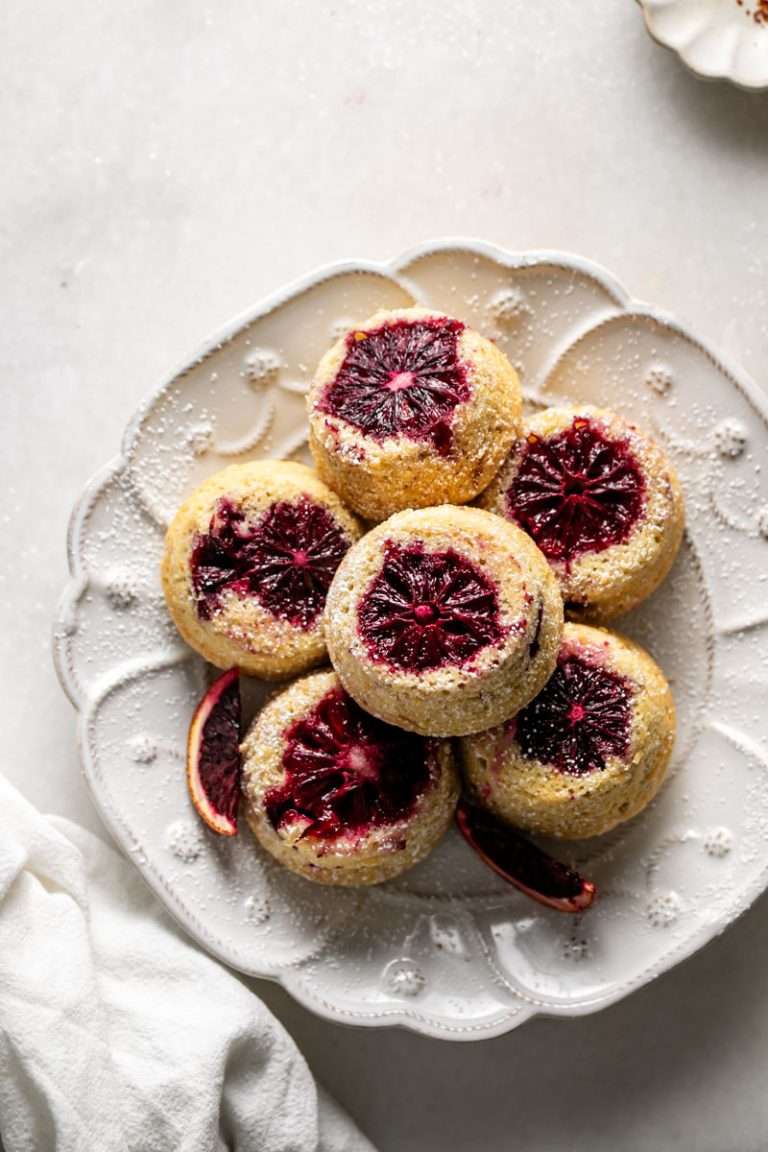 Blood orange upside down mini cakes topped with blood oranges, whipped cream and blood orange glaze. A versatile and easy dessert and cake recipe, perfect for Easter and spring and summer dessert menus.