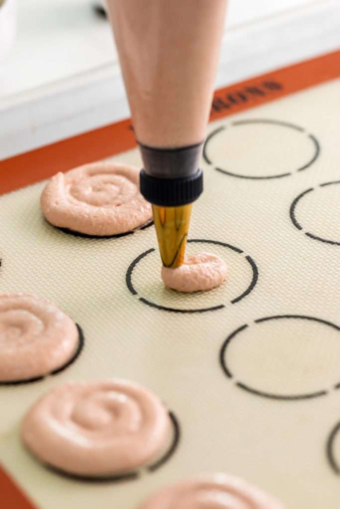 Cinnamon roll flavored macarons for breakfast and brunch. The swirled shells are filled with cinnamon roll white chocolate ganache and topped with icing for the ultimate cinnamon roll flavor. A gluten free recipe.