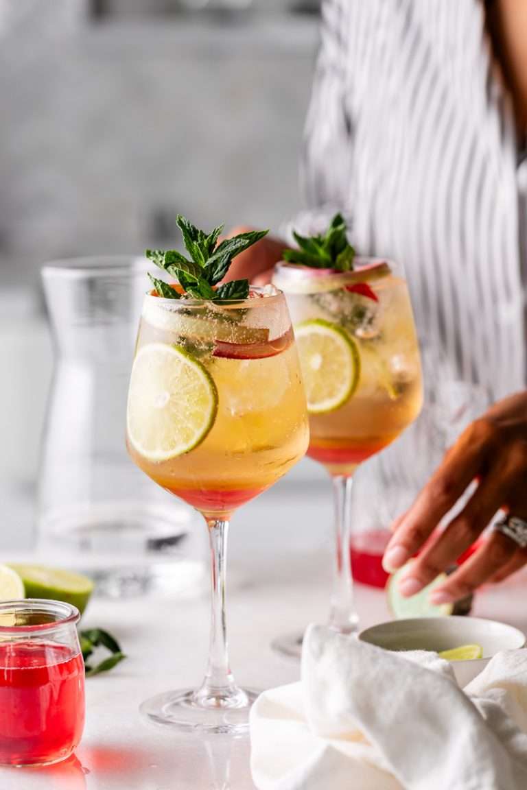 This refreshing Rhubarb Hugo Spritz is a delicious cocktail and aperitif for spring and summer gatherings, mixed with rhubarb simple syrup, St. Germain, prosecco, lime juice, club soda and mint.