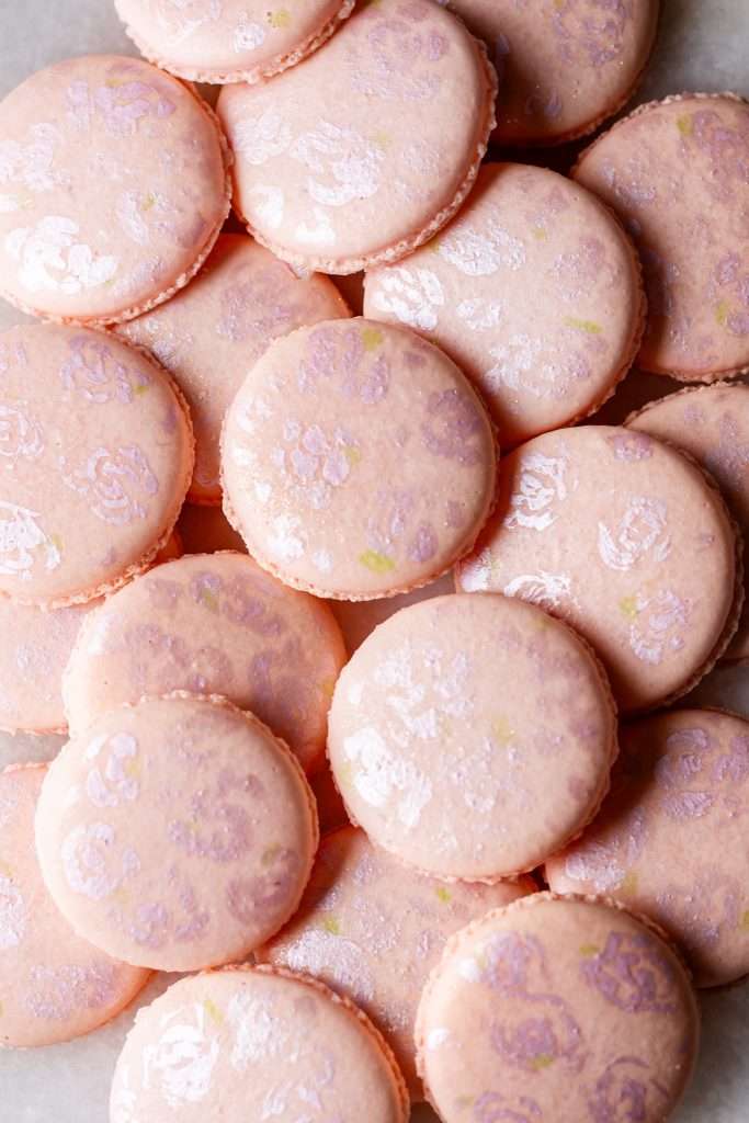 Hand painted floral macaron shells for coquette themed birthday party