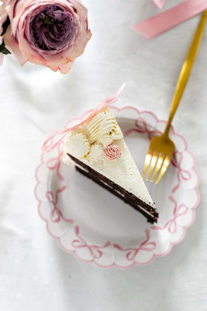Homemade vintage inspired birthday cake with rosettes and scalloped lambeth piped details.