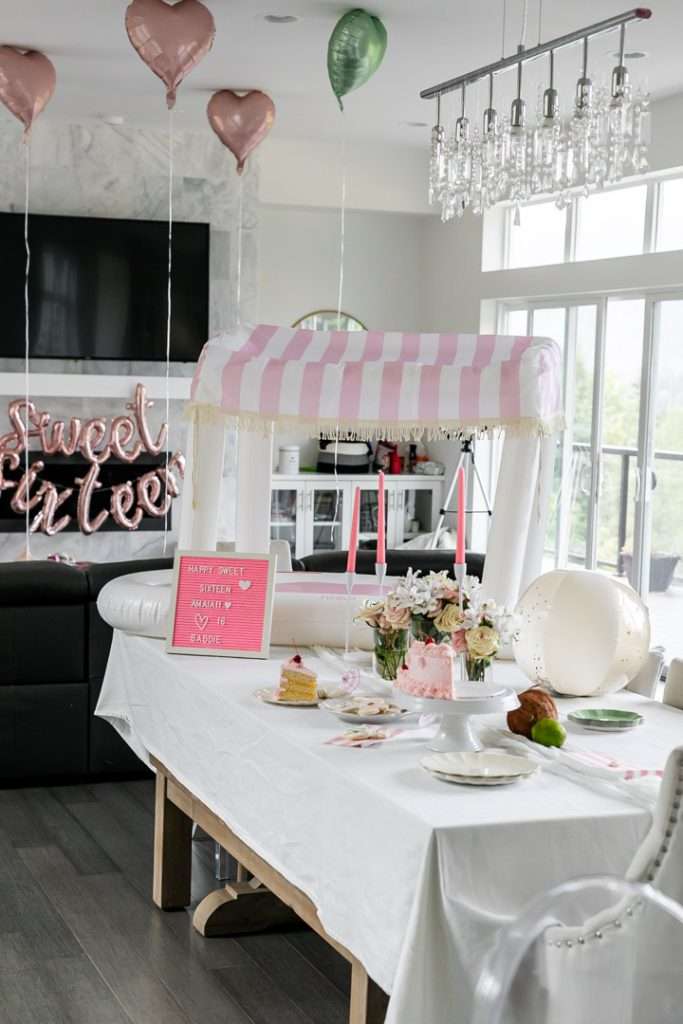 Cabana themed pool party decorations, complete with Fun Boy pink and white stripe cabana float.