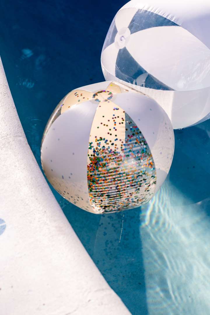 Glitter beach balls for teen cabana themed pool party.