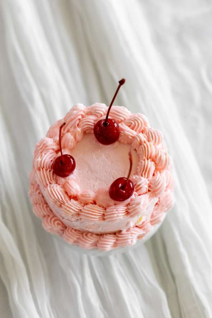 Tiny adorable pink piped lambeth cake for sweet sixteen birthday party.