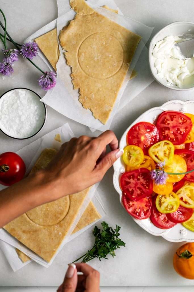 Mini tomato galettes, the perfect party appetizer or brunch treat! Flaky pastry, creamy goat cheese and fresh garden tomatoes, and baked until golden brown.