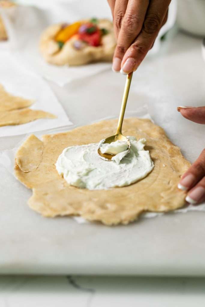 Mini tomato galettes, the perfect party appetizer or brunch treat! Flaky pastry, creamy goat cheese and fresh garden tomatoes, and baked until golden brown.
