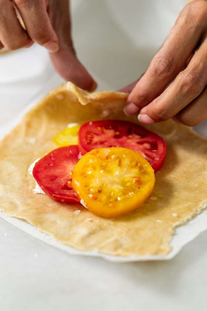 Mini tomato galettes, the perfect party appetizer or brunch treat! Flaky pastry, creamy goat cheese and fresh garden tomatoes, and baked until golden brown.