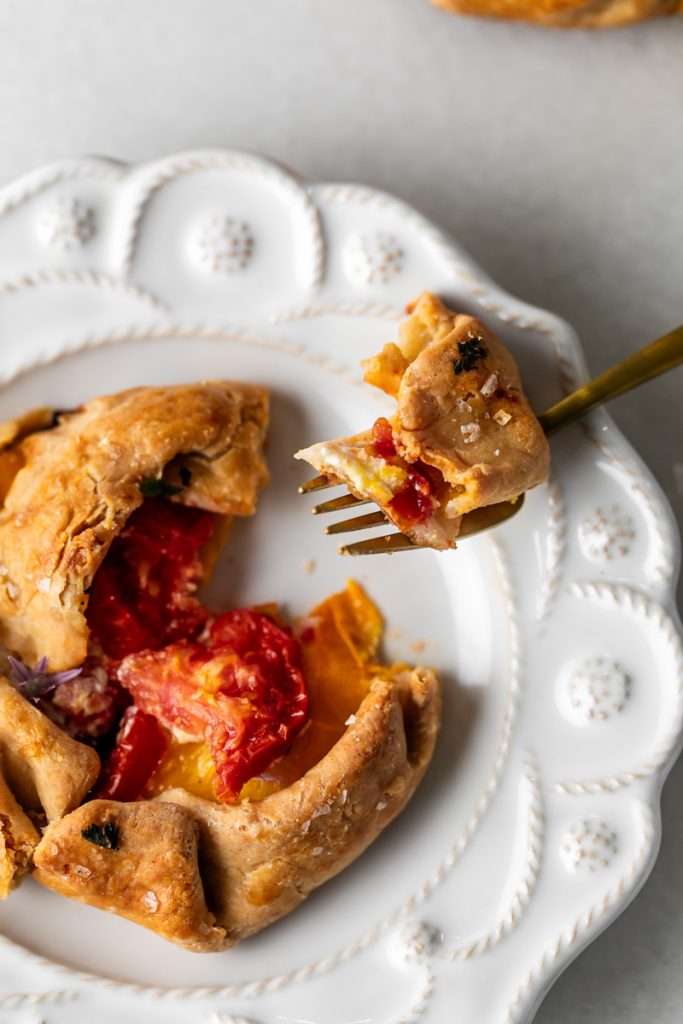 Mini tomato galettes, the perfect party appetizer or brunch treat! Flaky pastry, creamy goat cheese and fresh garden tomatoes, and baked until golden brown.