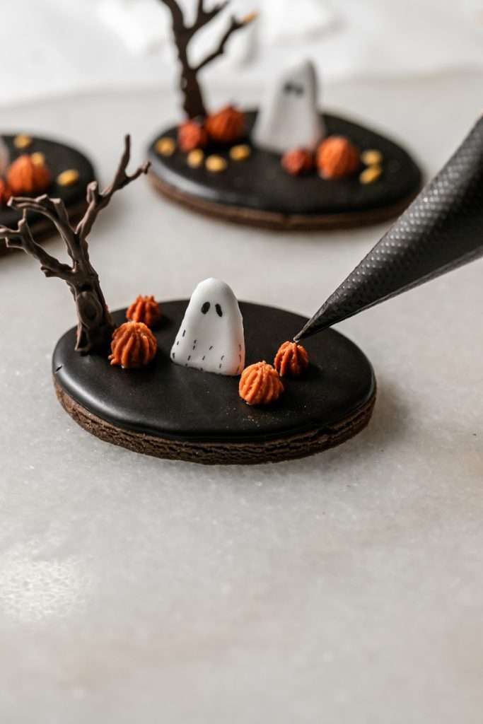 These 3D chocolate sugar cookies are decorated with rich chocolate royal icing and festive Halloween details. Featuring spooky icing transfers, they are not only delicious but perfect for dessert tables. cookie decorating inspiration and halloween themed parties.