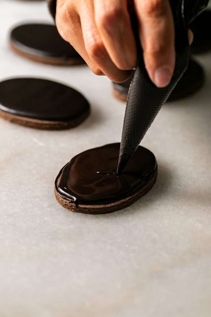 These 3D chocolate sugar cookies are decorated with rich chocolate royal icing and festive Halloween details. Featuring spooky icing transfers, they are not only delicious but perfect for dessert tables. cookie decorating inspiration and halloween themed parties.