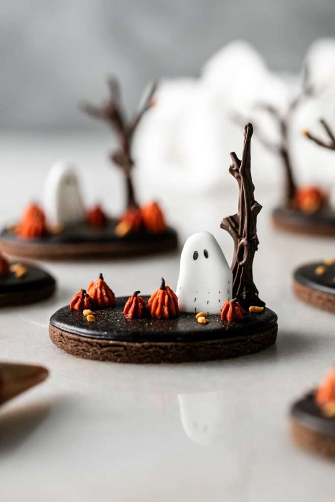 Rich chocolate sugar cookies topped with chocolate royal icing and spooky 3D Halloween details. A festive and delicious treat for the fall season, with step by step decorating instructions.