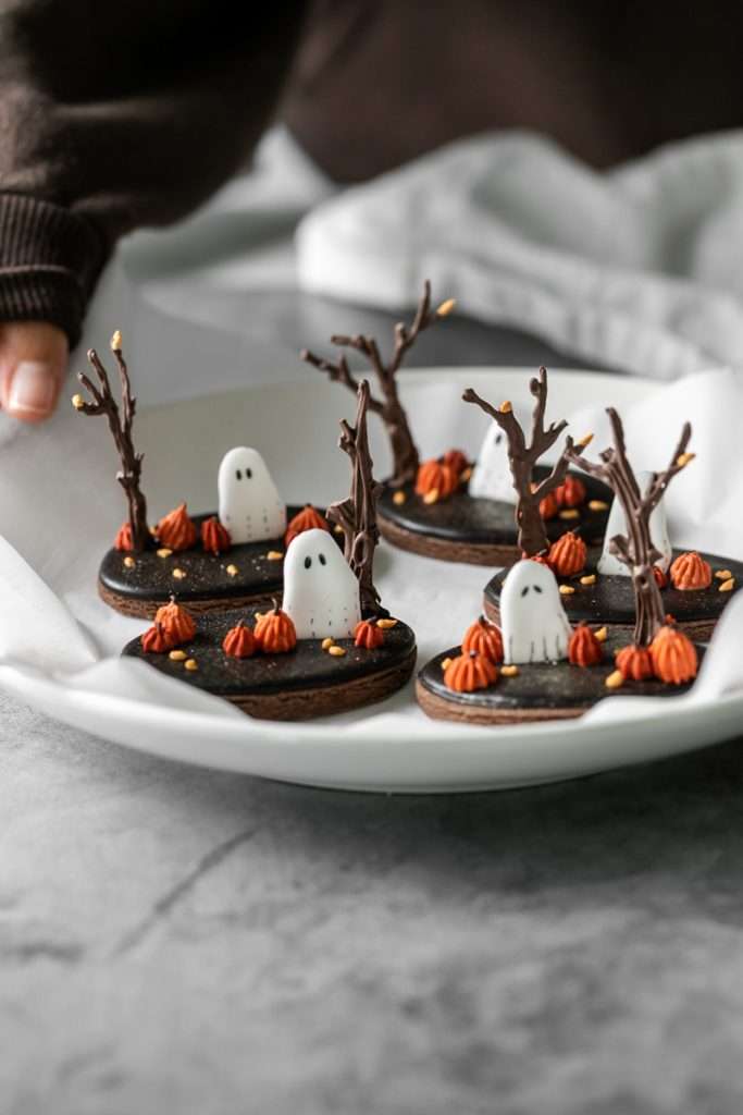 These 3D chocolate sugar cookies are decorated with rich chocolate royal icing and festive Halloween details. Featuring spooky icing transfers, they are not only delicious but perfect for dessert tables. cookie decorating inspiration and halloween themed parties.