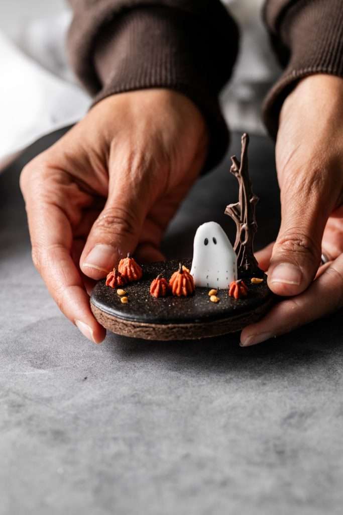 Rich chocolate sugar cookies topped with chocolate royal icing and spooky 3D Halloween details. A festive and delicious treat for the fall season, with step by step decorating instructions.